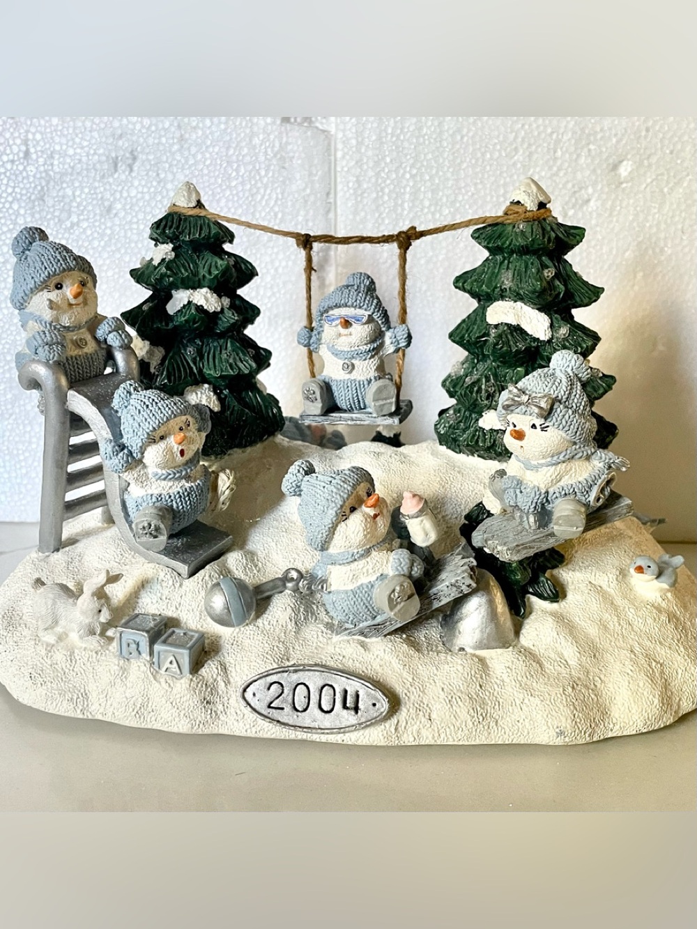 Festive Snow Buddies figurine featuring snowmen playing in the snow.